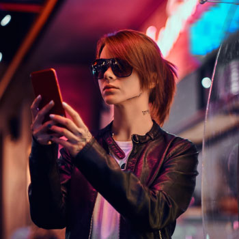 stylish-redhead-girl-using-a-phone-while-standing--7E9SDL9
